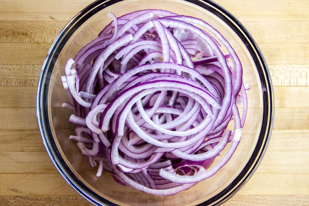 Thinly slice the red onion. Cut into desired size and length.