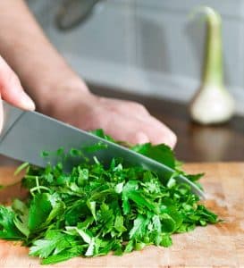 Chop fresh cilantro for the Baked Tortilla Bowls with Chipotle Chickpea Salad