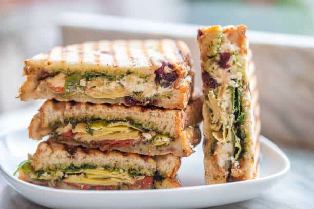 Stacked Vegetarian Sandwiches of Arugula Artichoke sun Dried Tomato